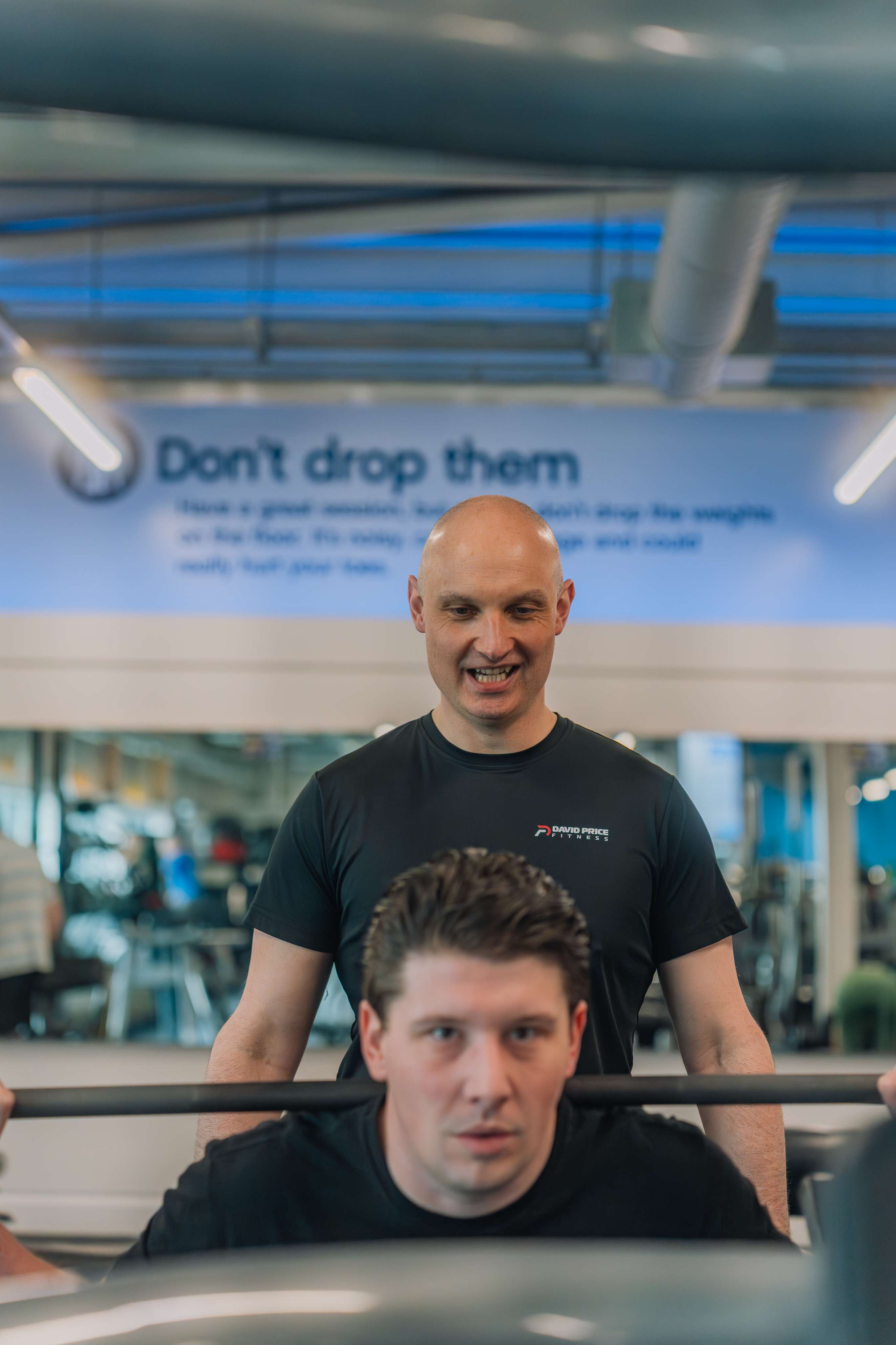 Personal trainer in Norwich coaching a client through a squat exercise focusing on technique and form